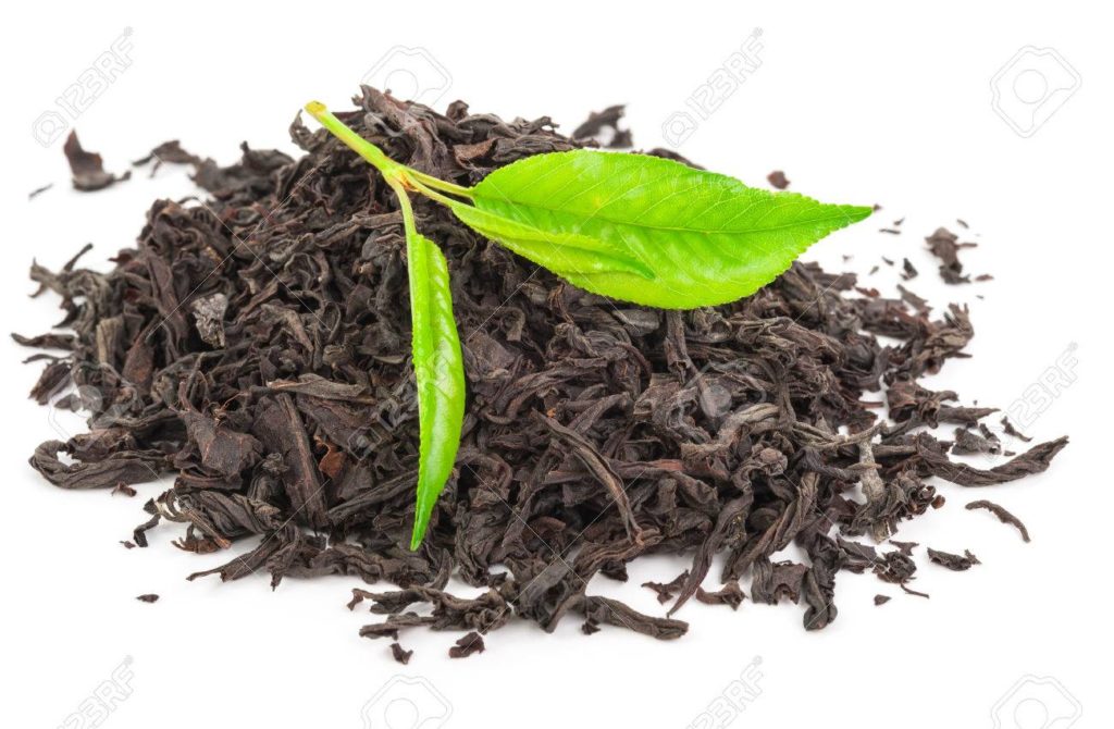 Heap of dry black tea with green tea leaves