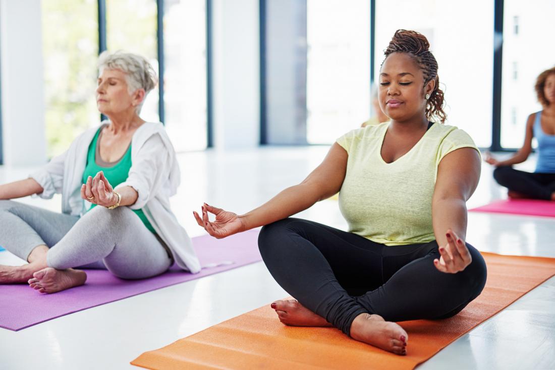 women doing yoga in a bright room