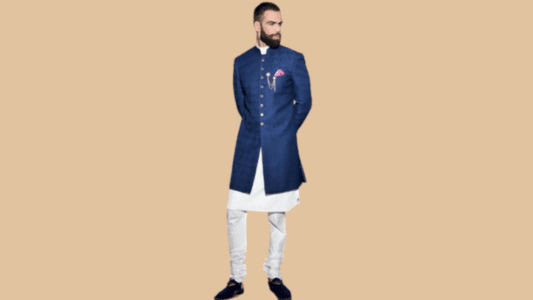 Shirt-trouser set layered with an Achkan coat